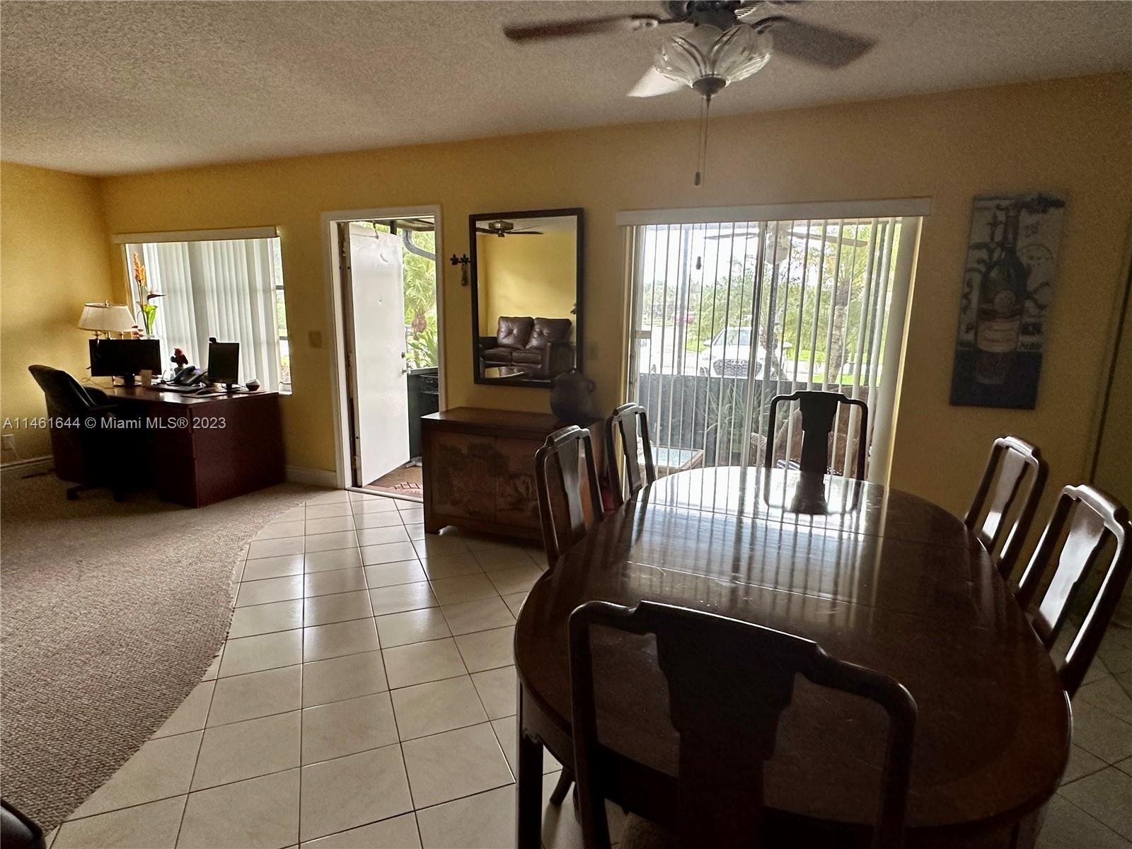 14711 Edna Way Delray Beach, FL 33484 - Photo 8 of 23 a living room with furniture and a floor to ceiling window