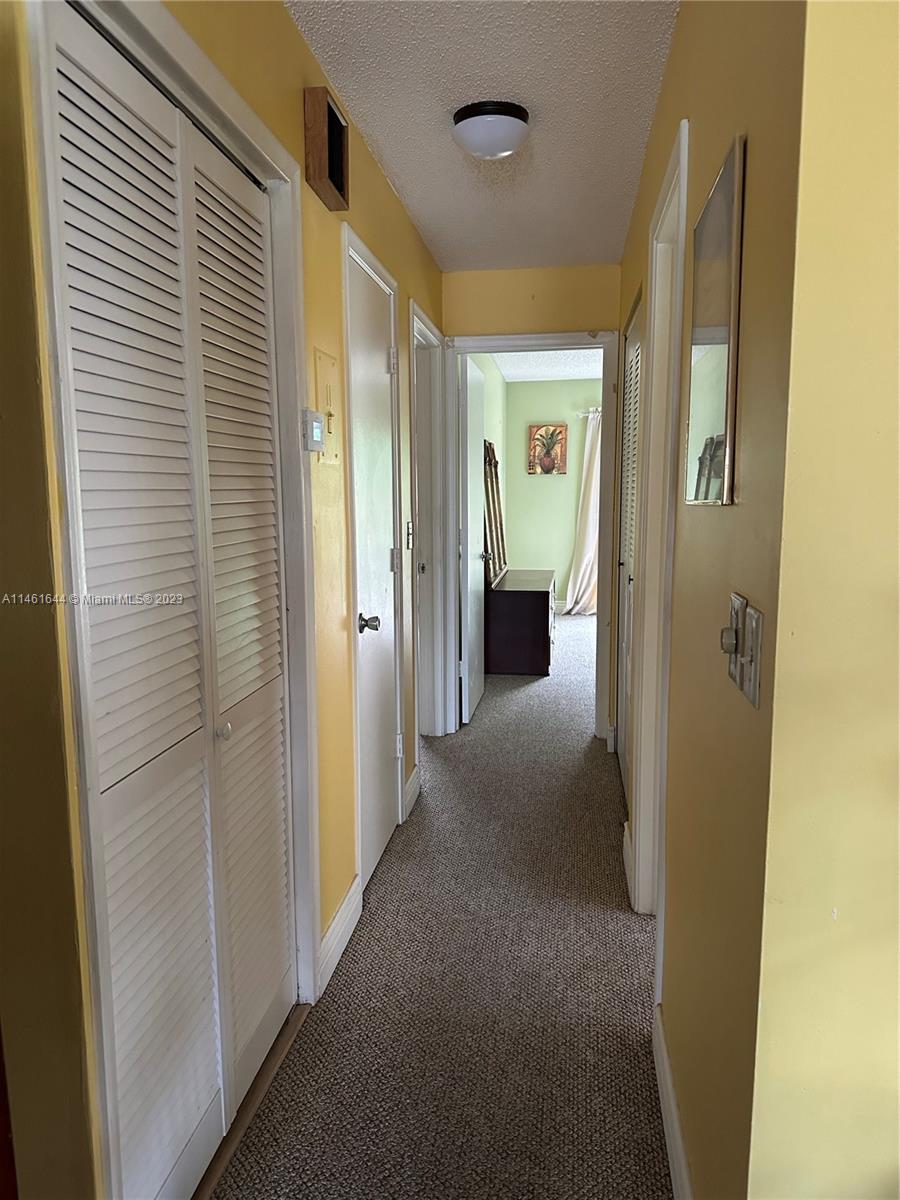 14711 Edna Way Delray Beach, FL 33484 - Photo 9 of 23 a view of a hallway with wooden shelves