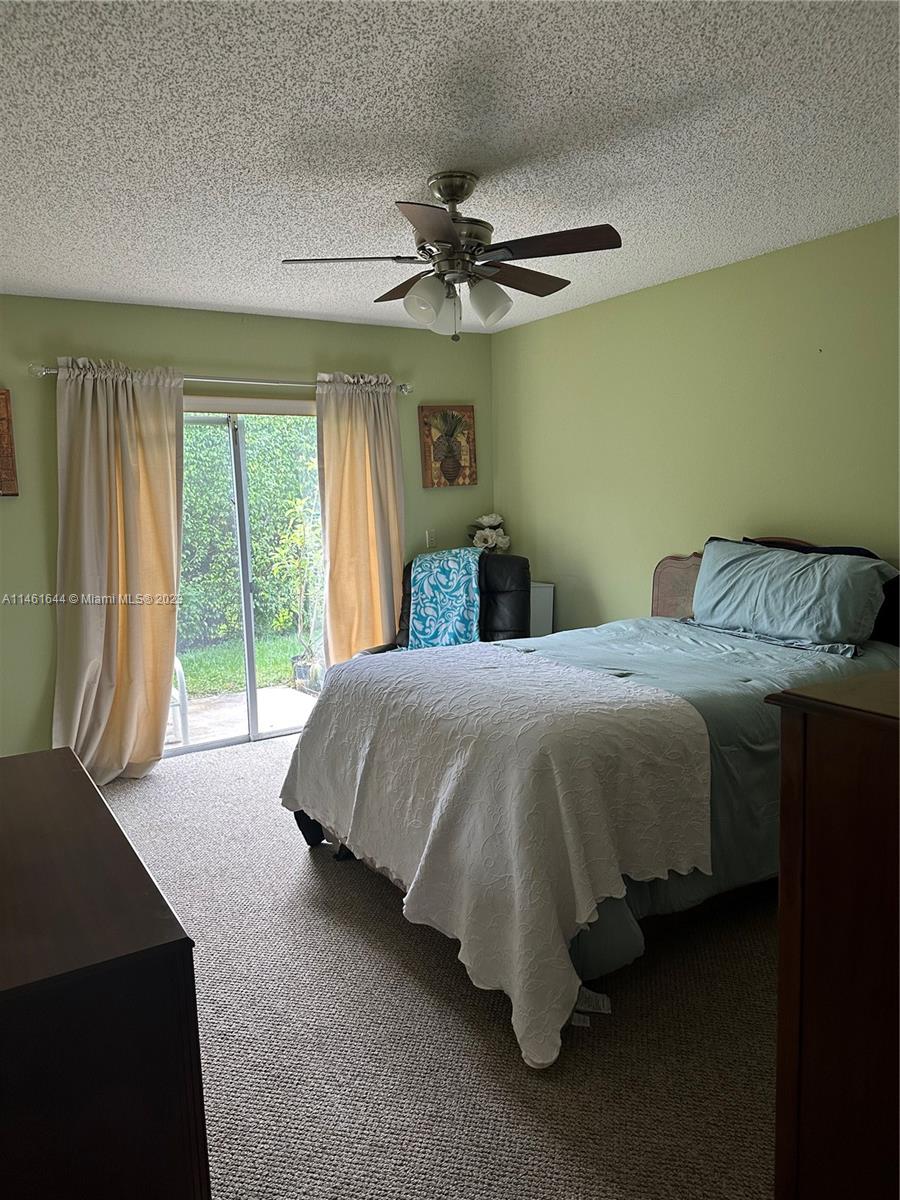 14711 Edna Way Delray Beach, FL 33484 - Photo 10 of 23 a bedroom with a bed and window