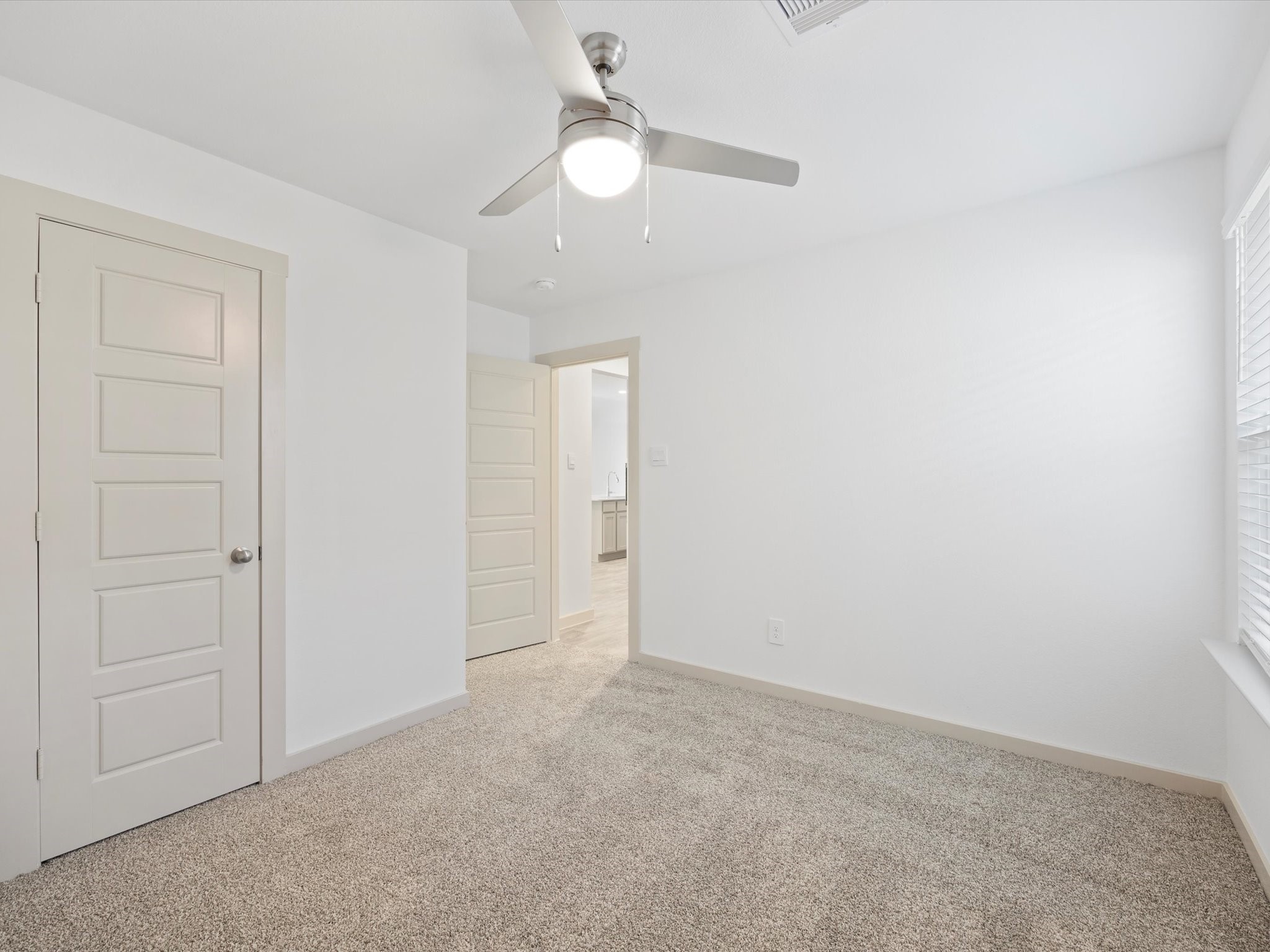 12733 Ermine Street Houston, TX 77047 - Photo 11 of 15 a view of an empty room and a chandelier fan