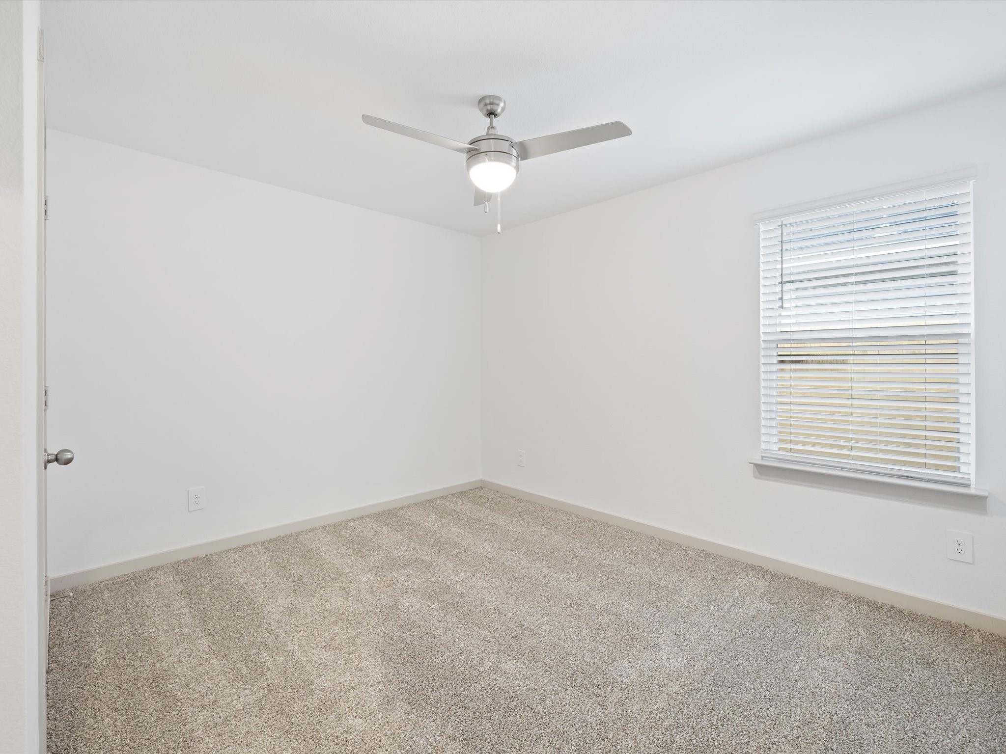12733 Ermine Street Houston, TX 77047 - Photo 12 of 15 an empty room with a window and a fan