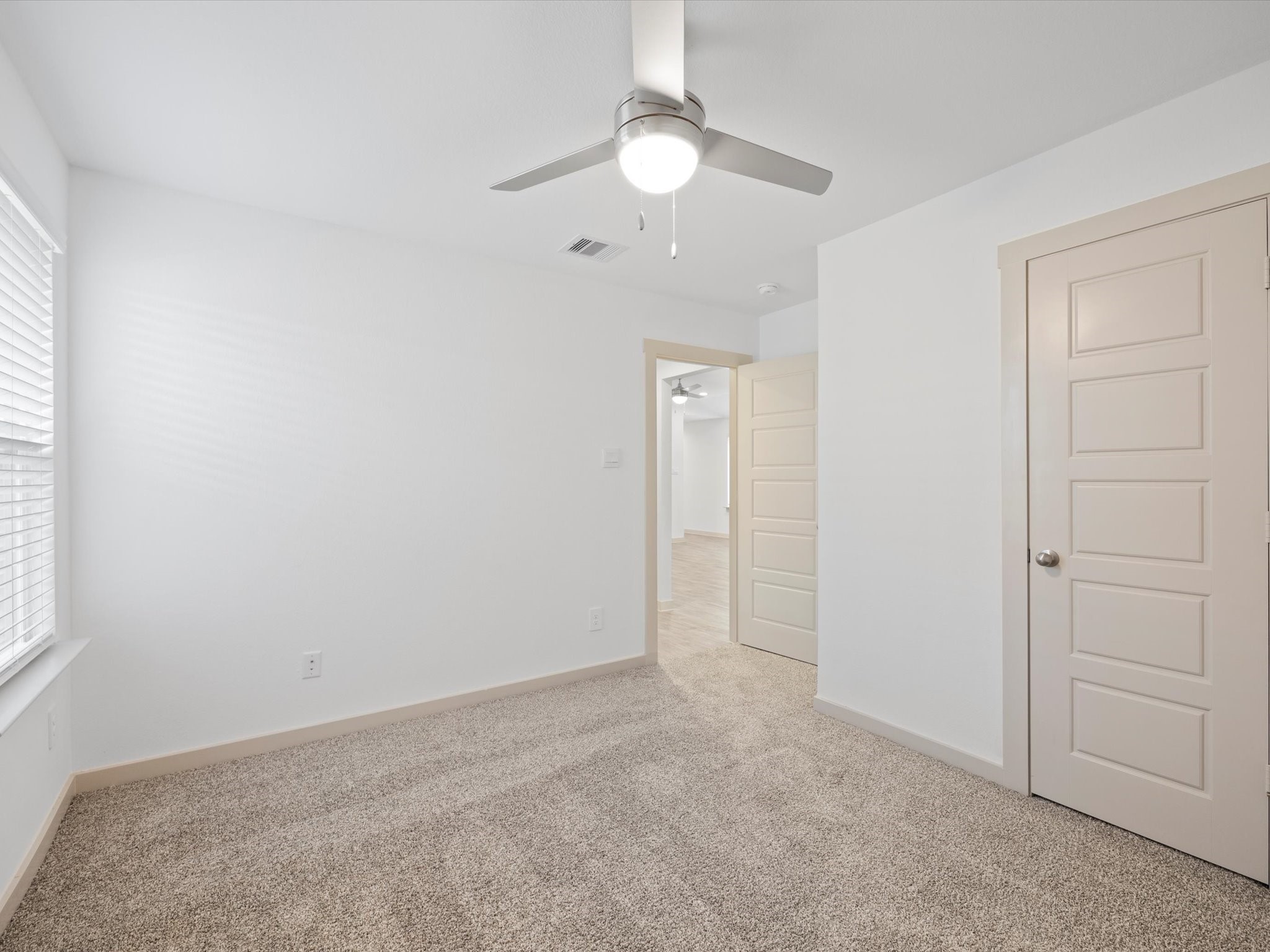 12733 Ermine Street Houston, TX 77047 - Photo 13 of 15 an empty room with a fan & a window