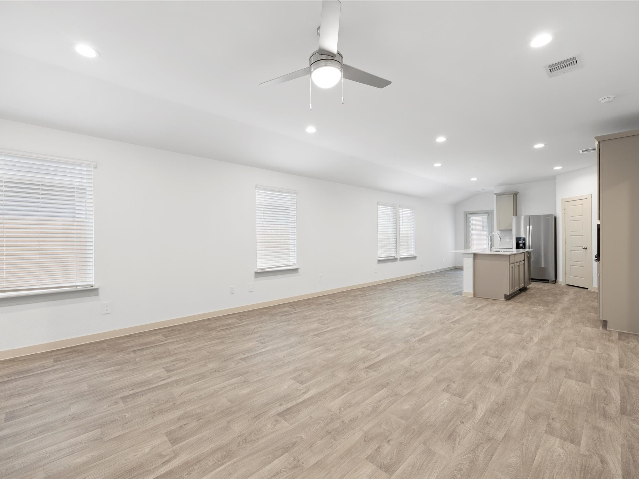 12733 Ermine Street Houston, TX 77047 - Photo 4 of 15 a view of an empty room with a kitchen