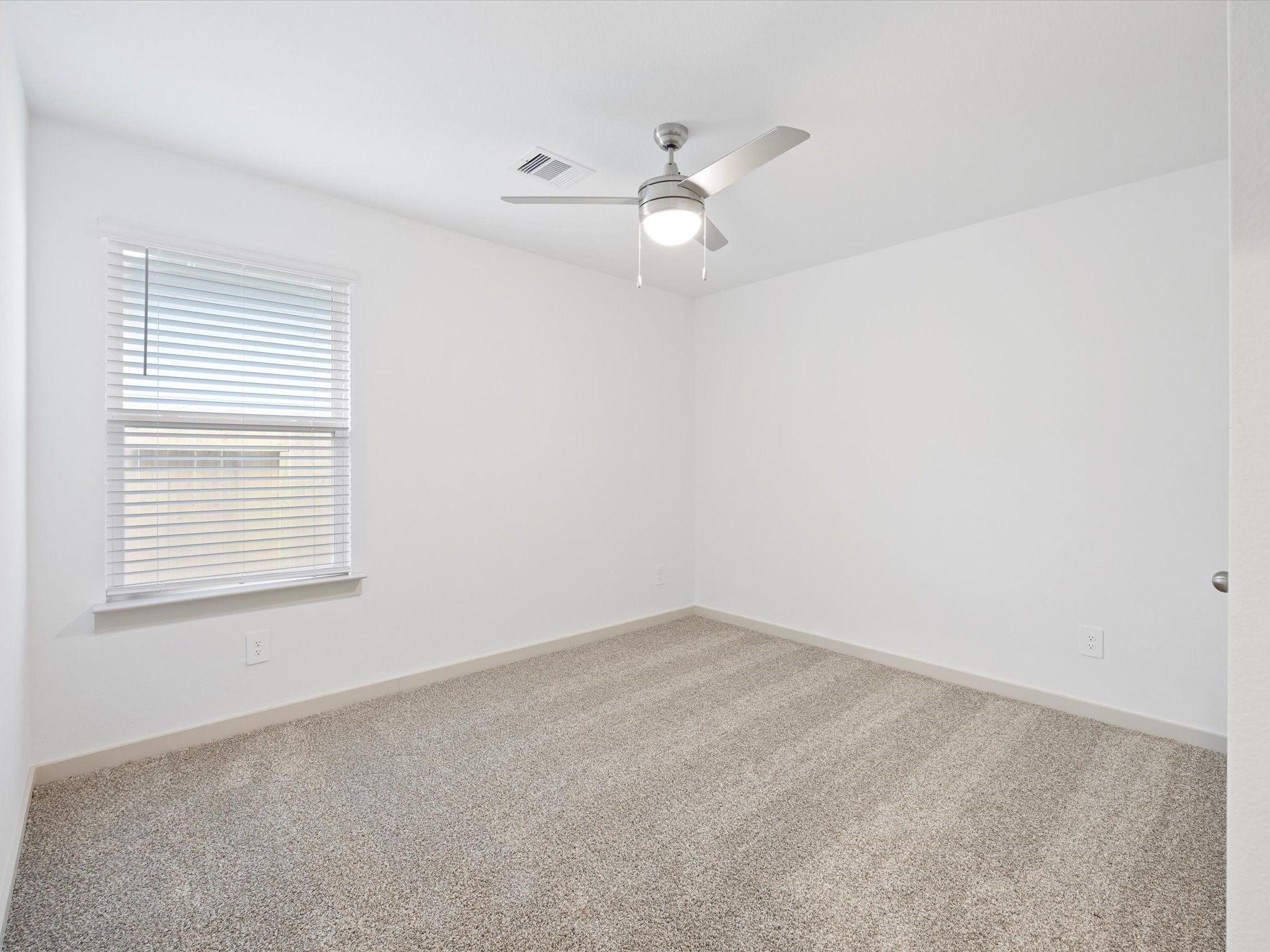 12733 Ermine Street Houston, TX 77047 - Photo 10 of 15 an empty room with a window and ceiling fan