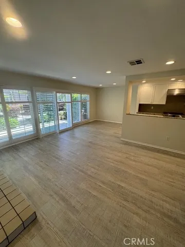 a view of a kitchen with a sink and a refrigerator