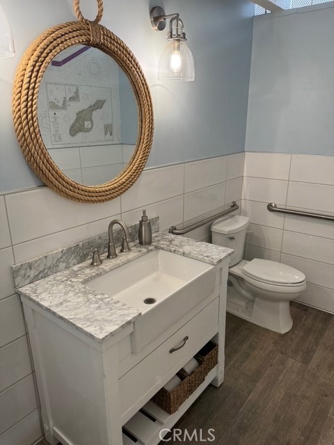 4455 West Coast Highway, Unit 23 Newport Beach, CA 92663 - Photo 6 of 30 a bathroom with a sink and a toilet