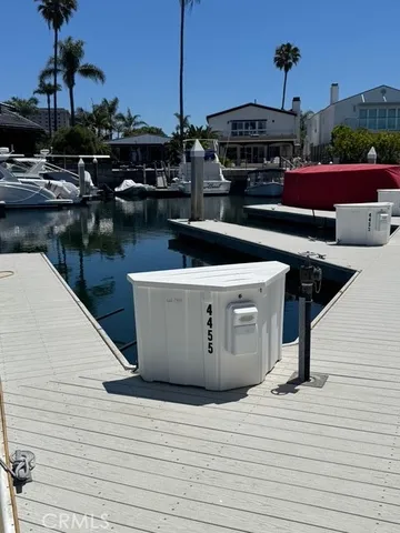 a roof deck with table and chairs a barbeque