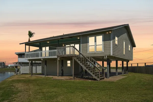 a front view of a house with yard and balcony