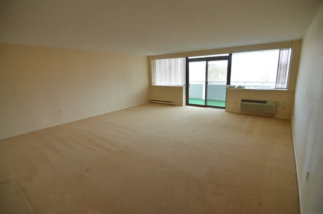 an empty room with large windows