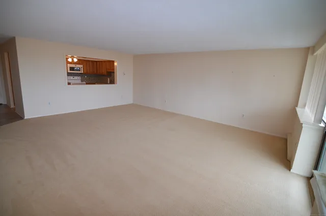 a view of an empty room and a window