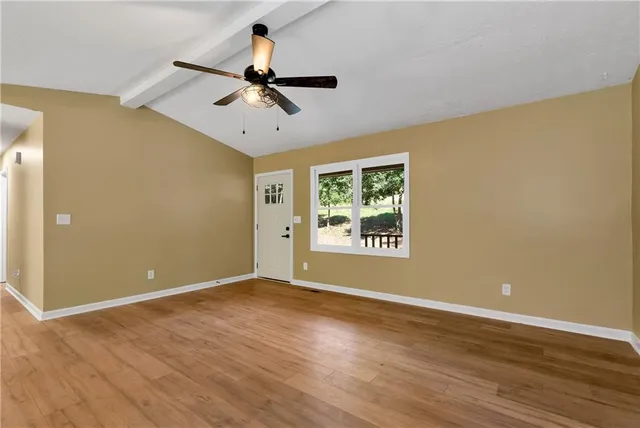 wooden floor in an empty room with a window