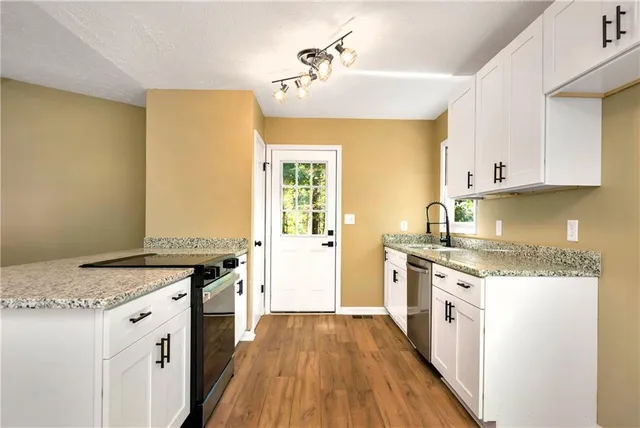 a kitchen with a stove top oven sink and cabinets