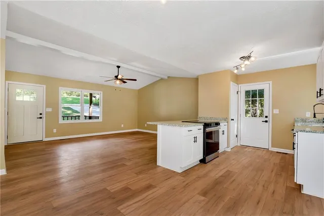 a kitchen with a refrigerator and a stove top oven