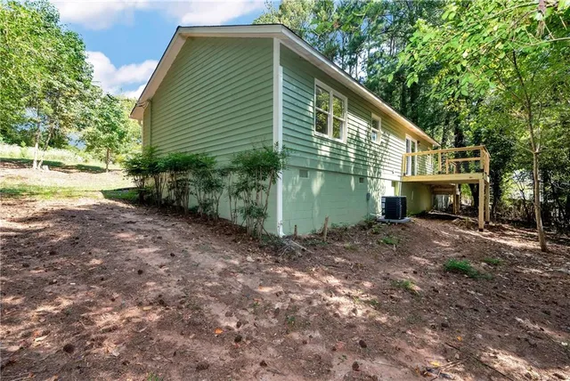 a backyard of a house with plants and tree