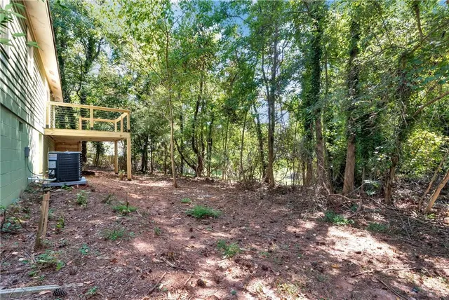 a view of a house with a tree in the background