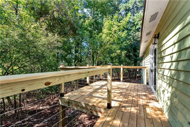 a view of a balcony with wooden floor and fence