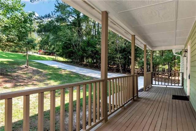 a view of a porch with wooden floor and yard