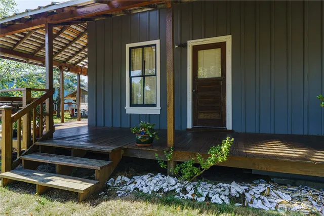 a view of a house with backyard and sitting area