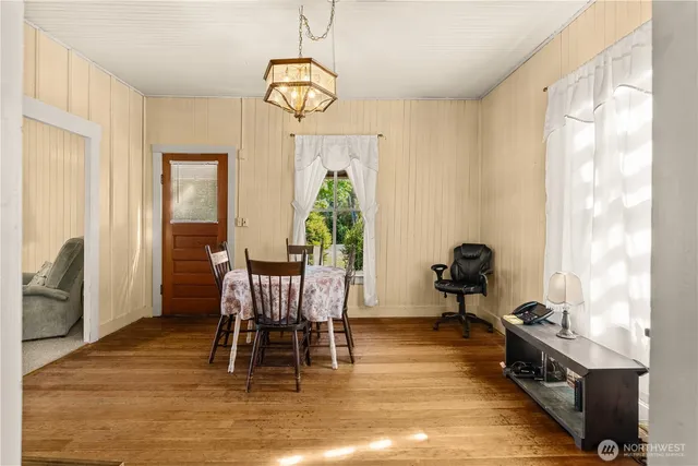 a view of a dining room with furniture window and wooden floor