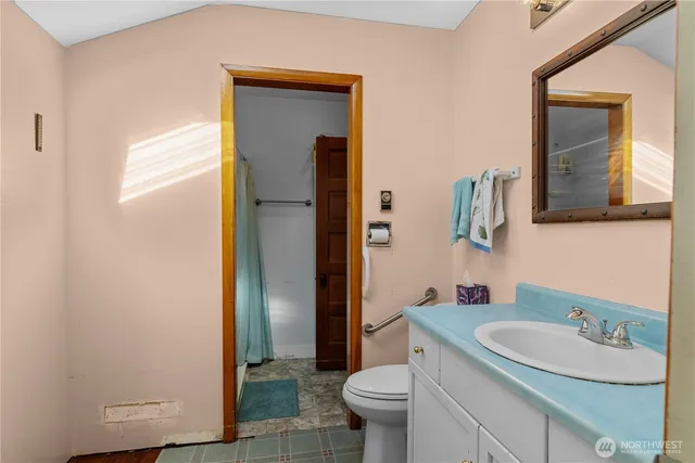 a bathroom with a sink toilet and shower