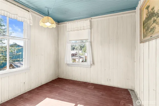 a view of a room with wooden floor and windows