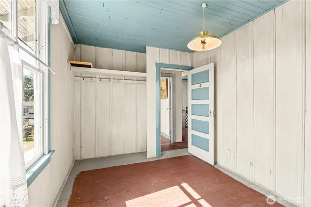 a view of an empty room with a window and gate
