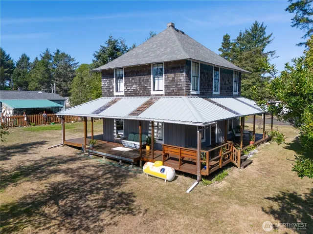 an aerial view of a house with swimming pool and porch