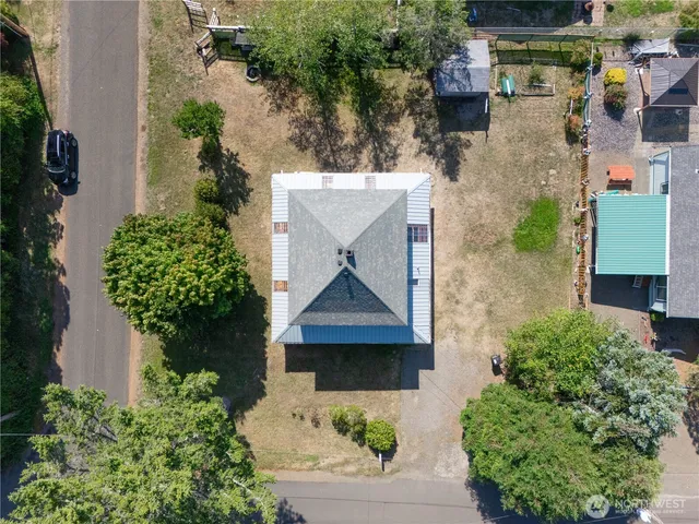 an aerial view of a house with a yard