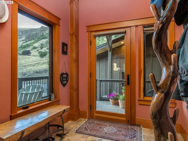a view of an entryway with wooden floor and door