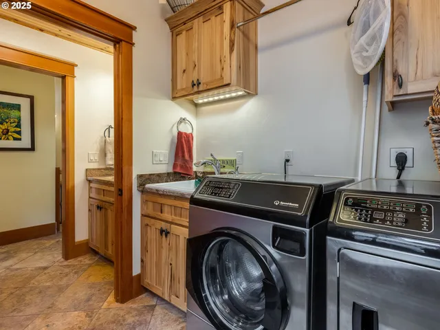 a view of storage and utility room with washer and dryer