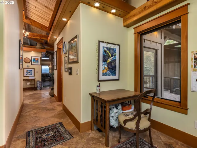 a view of a hallway with furniture and front door
