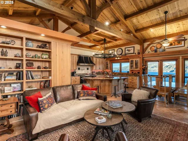 a living room with furniture and a view of kitchen