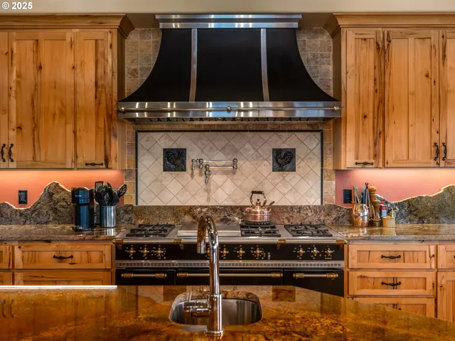 a stove top oven sitting inside of a kitchen