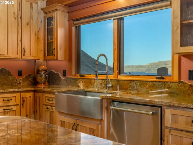 a kitchen with stainless steel appliances granite countertop a sink and a cabinets