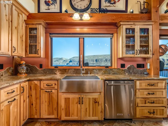 a view of a kitchen with granite countertop a stove and a sink