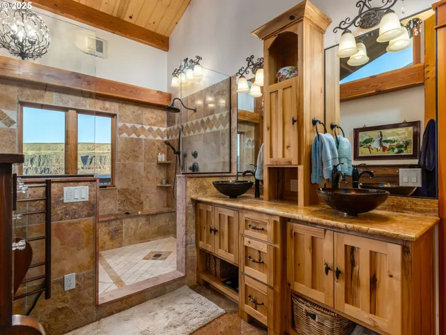 a bathroom with a tub sink and large window