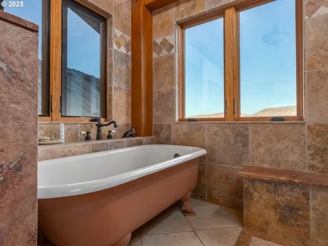 a view of a house with pool and chairs
