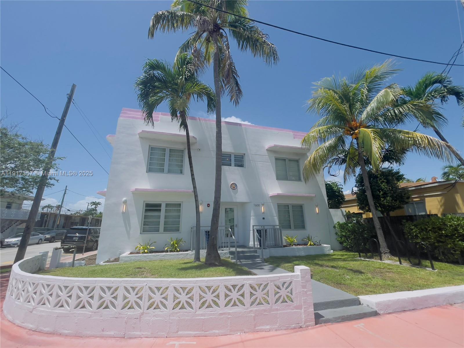 7600 Harding Avenue, Unit 705 Miami Beach, FL 33141 - Photo 2 of 10 a front view of a house with a garden and yard