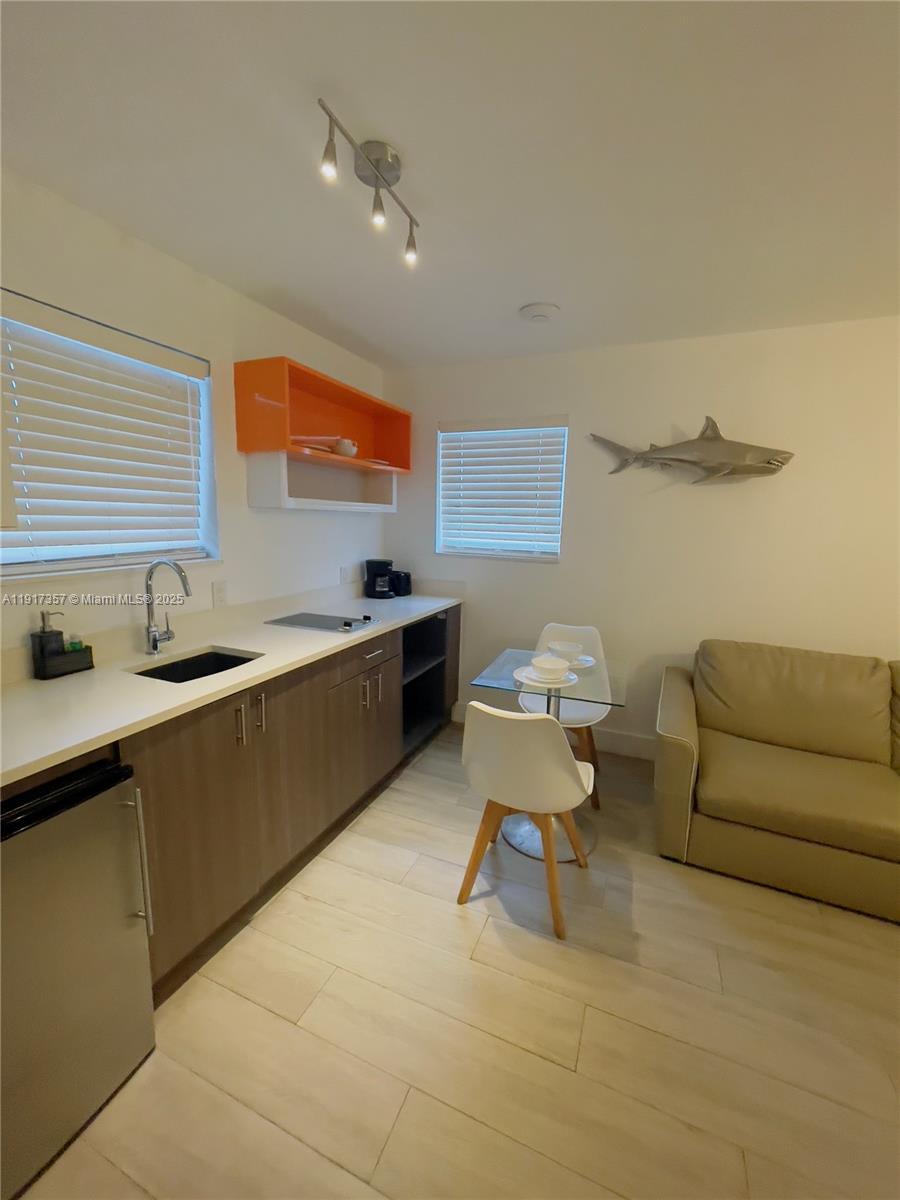 7600 Harding Avenue, Unit 705 Miami Beach, FL 33141 - Photo 9 of 10 a living room with furniture and a table