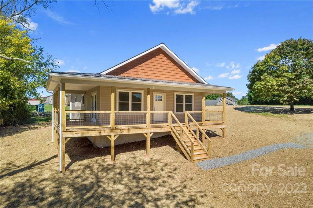 a view of a house with backyard porch and sitting area