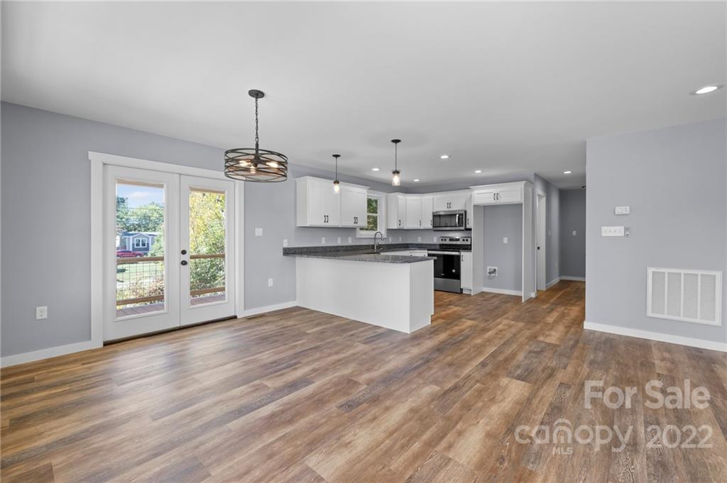 8 Split Rail Drive Asheville, NC 28806 - Photo 11 of 24 a view of a kitchen with a stove cabinets and wooden floor