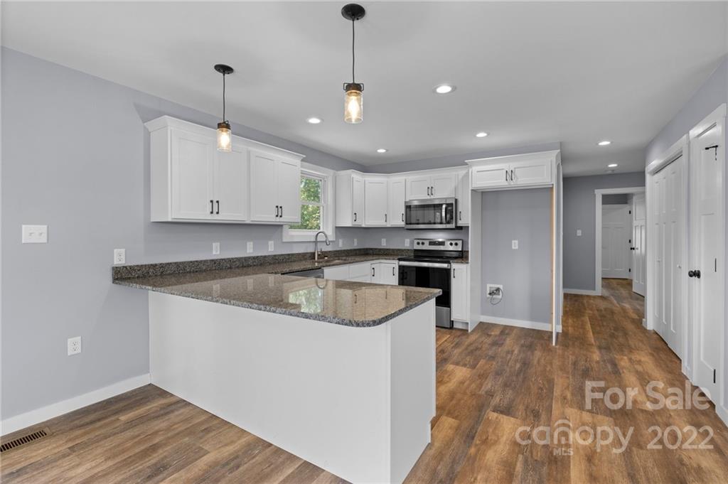 8 Split Rail Drive Asheville, NC 28806 - Photo 13 of 24 a large kitchen with stainless steel appliances granite countertop a sink a stove and a refrigerator