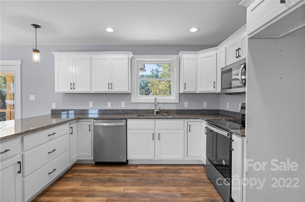 8 Split Rail Drive Asheville, NC 28806 - Photo 14 of 24 a kitchen with stainless steel appliances granite countertop a sink stove and cabinets