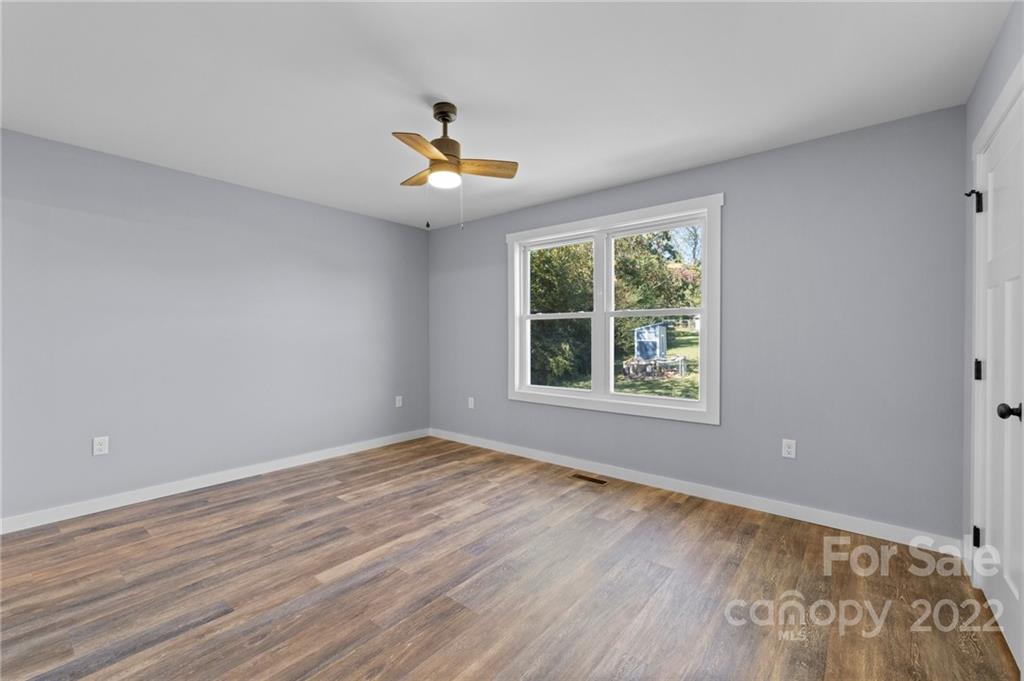 8 Split Rail Drive Asheville, NC 28806 - Photo 17 of 24 a view of an empty room with wooden floor and a window