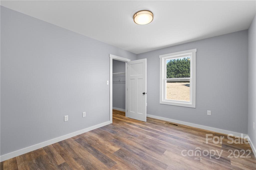 8 Split Rail Drive Asheville, NC 28806 - Photo 19 of 24 an empty room with wooden floor and windows