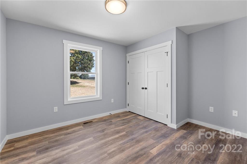8 Split Rail Drive Asheville, NC 28806 - Photo 21 of 24 a view of empty room with wooden floor and fan