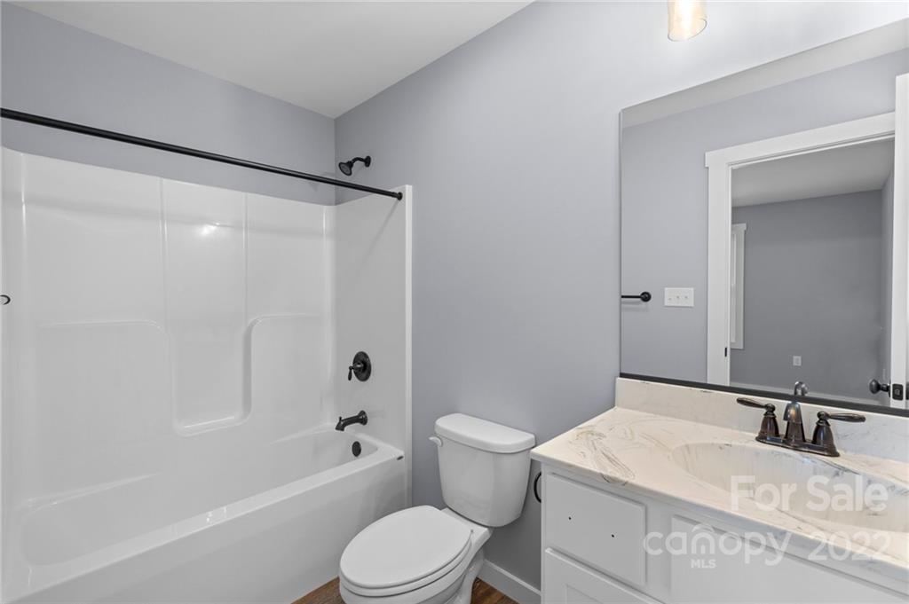 8 Split Rail Drive Asheville, NC 28806 - Photo 23 of 24 a bathroom with a granite countertop sink a toilet a mirror and shower