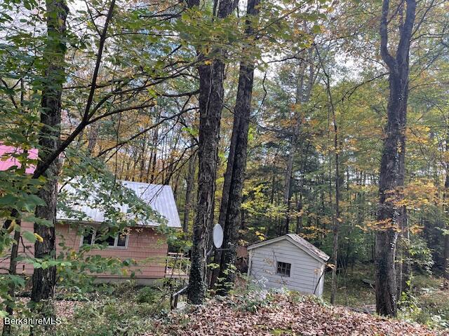 23 Judd Road Otis, MA 01253 - Photo 3 of 21 a view of house with a yard and potted plants
