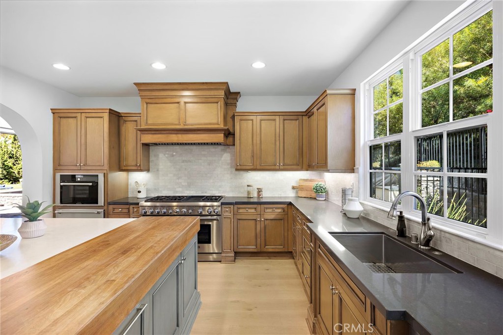 4 Gaucho Road Ladera Ranch, CA 92694 - Photo 12 of 40 a kitchen with a sink stove top oven and cabinets