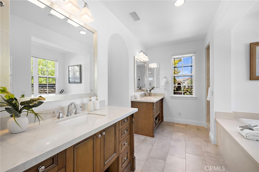 4 Gaucho Road Ladera Ranch, CA 92694 - Photo 20 of 40 a bathroom with a sink a faucet a mirror and a bathtub